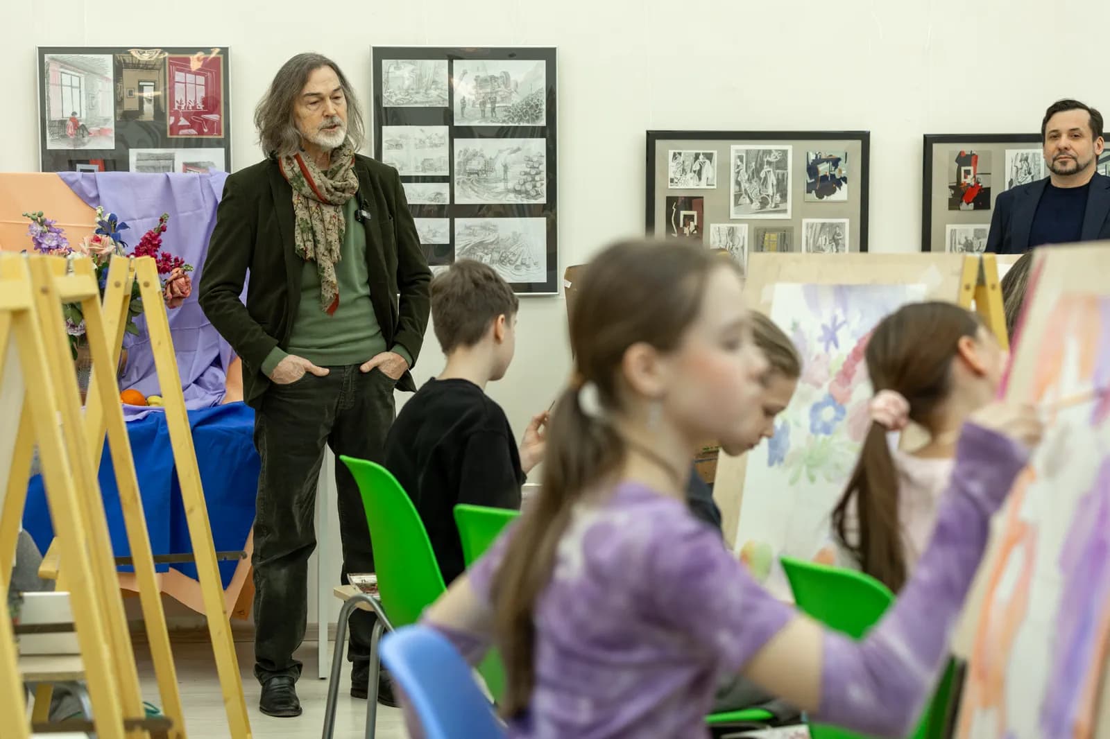 Nikas Safronov reviewing the participants' works